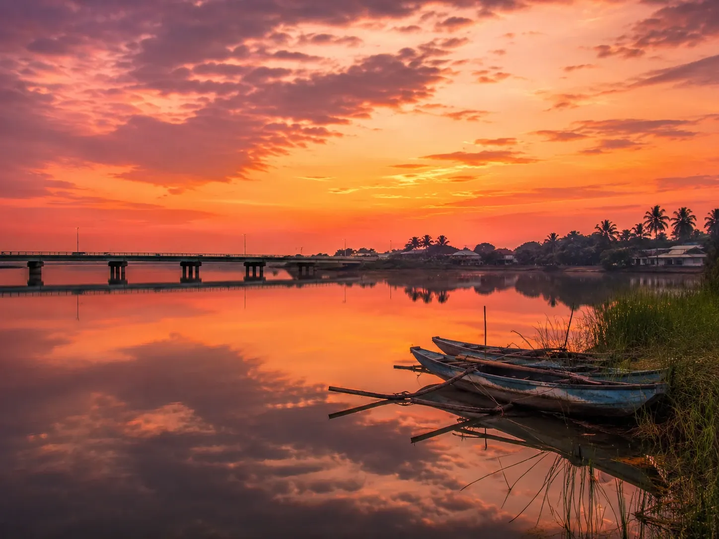 Fishing canoes on the still Batticaloa lagoon at sunset, east coast of Sri Lanka