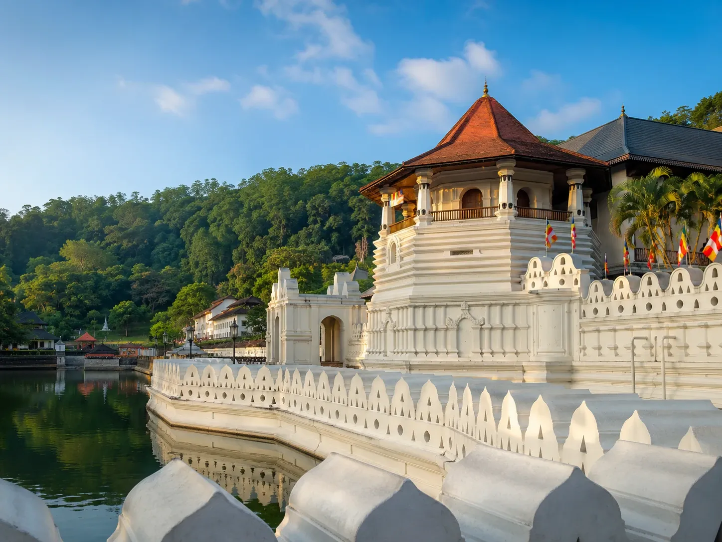 The Temple of the Sacred Tooth Relic reflected in Kandy Lake, Central Province, Sri Lanka