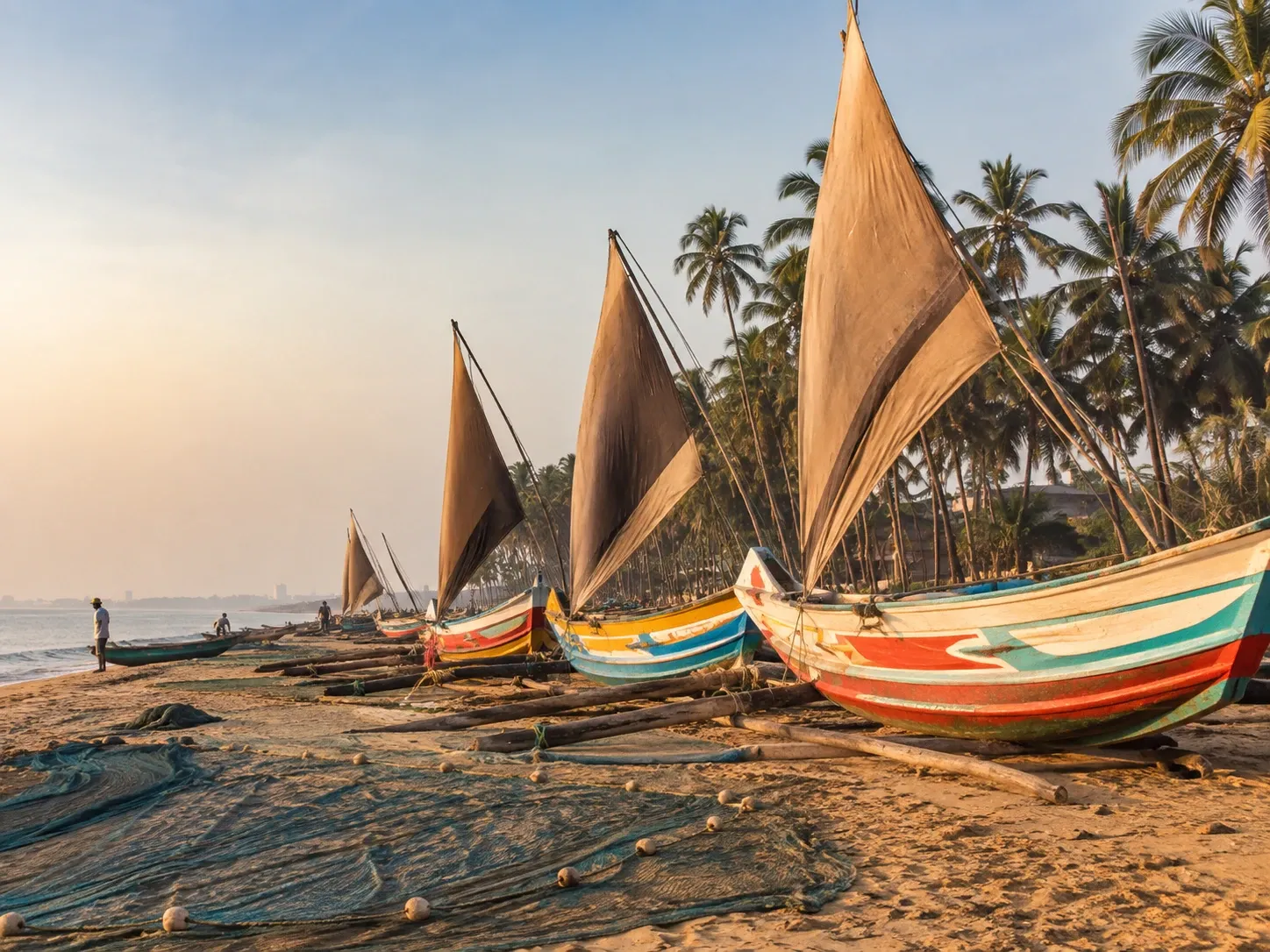 Traditional oruwa outrigger fishing boats drawn up on Negombo beach on the west coast of Sri Lanka