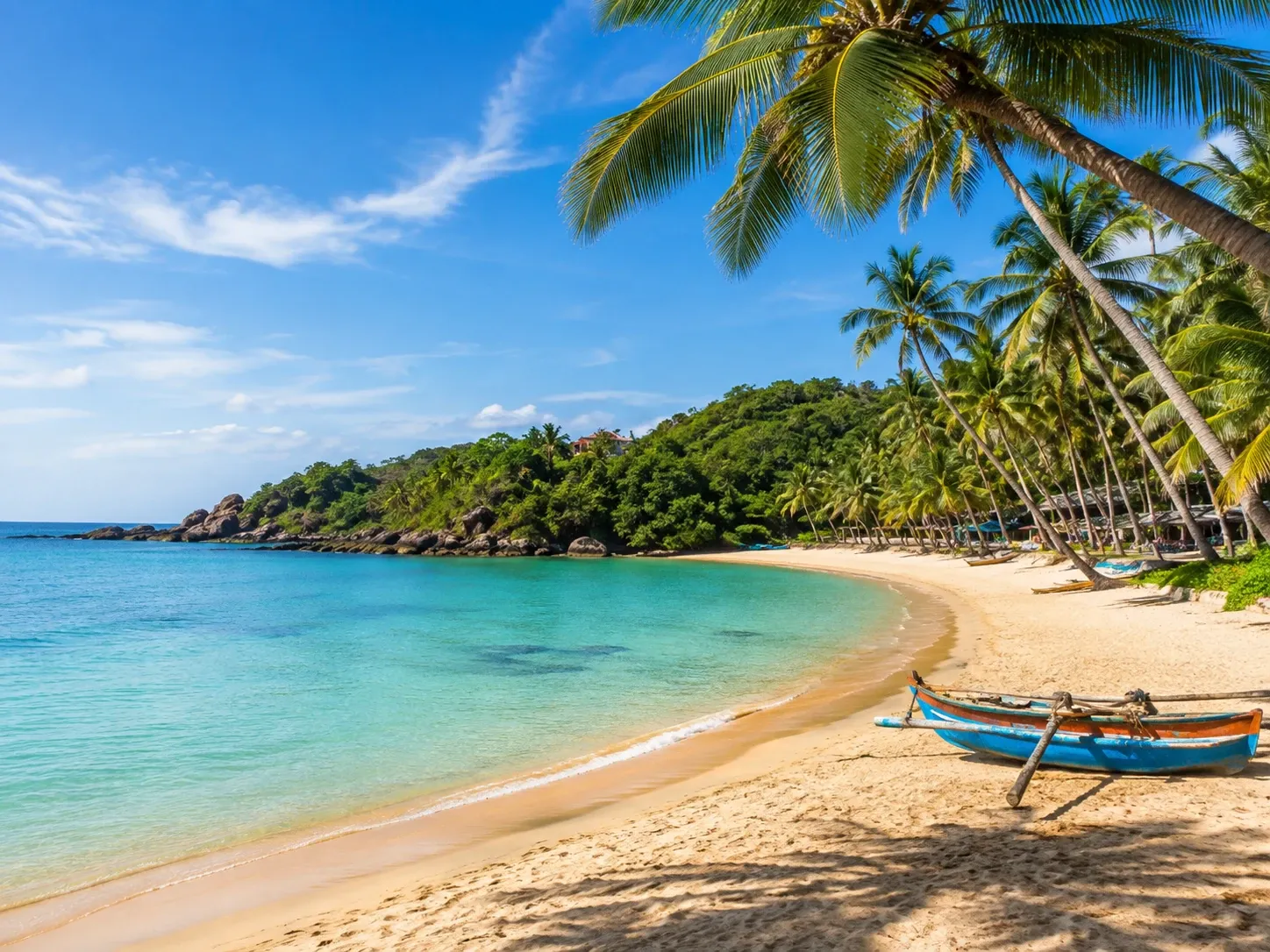 The sheltered crescent bay and leaning coconut palms at Unawatuna near Galle, Sri Lanka